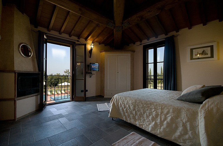Bedroom with fireplace in a Tuscan country cottage
