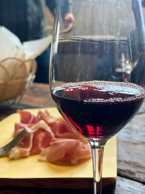 Tasting of red wine with local prosciutto