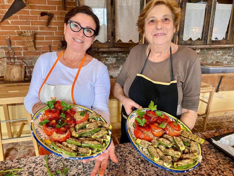 Ester and Elisabetta preparing stuffed zucchini and tomatoes